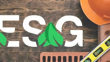 Capacete laranja, tijolos e madeira com a inscrição ESG por cima.